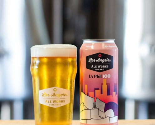 LA Phil 100 Brut IPA beer in glass next to can
