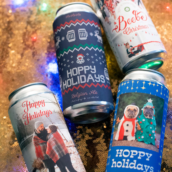 Four beer cans displaying examples of custom holiday labels