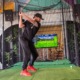 Man swinging a golf club in a Virtual Golf setup