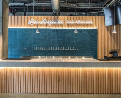 Los Angeles Ale Works sign and tap handles alongside back of bar