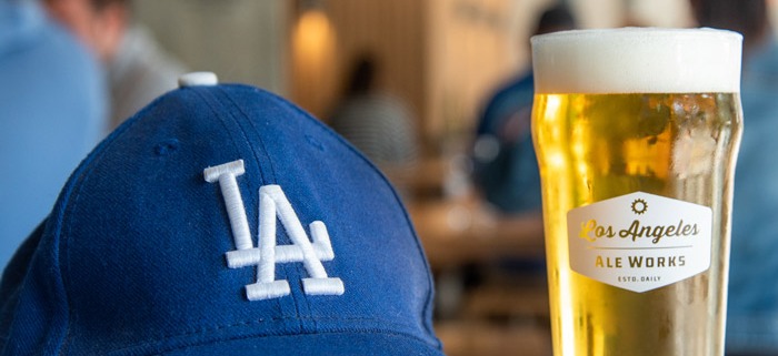 Blue LA hat next to glass of beer
