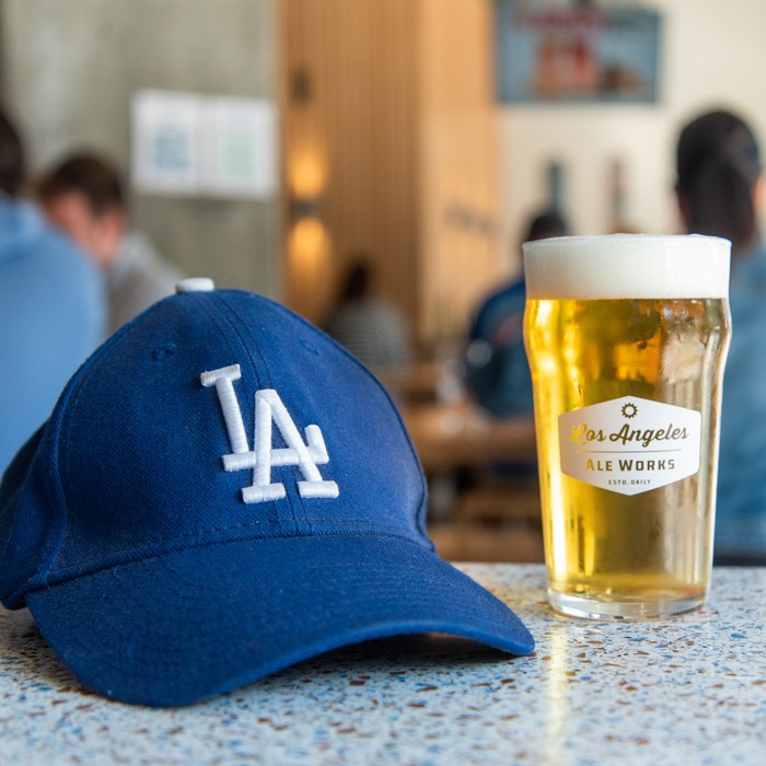 Blue LA hat next to glass of beer