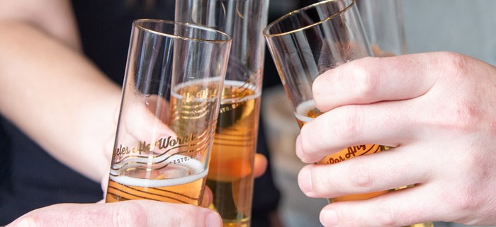 Closeup of group of people toasting with beer glasses