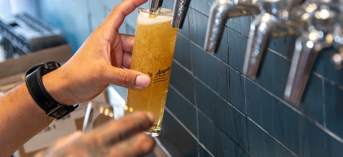Beer taps pouring into glass