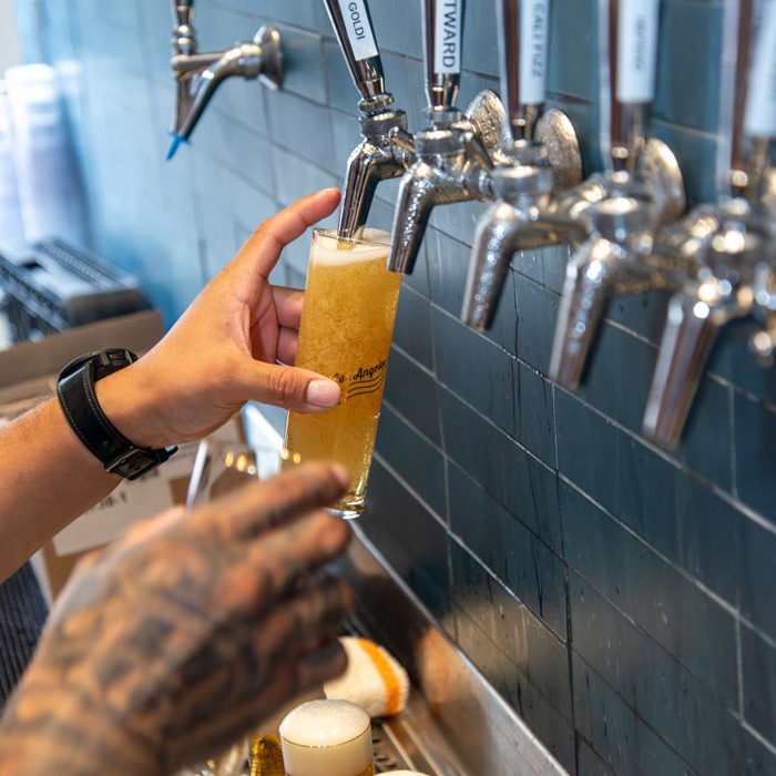 Beer taps pouring into glass
